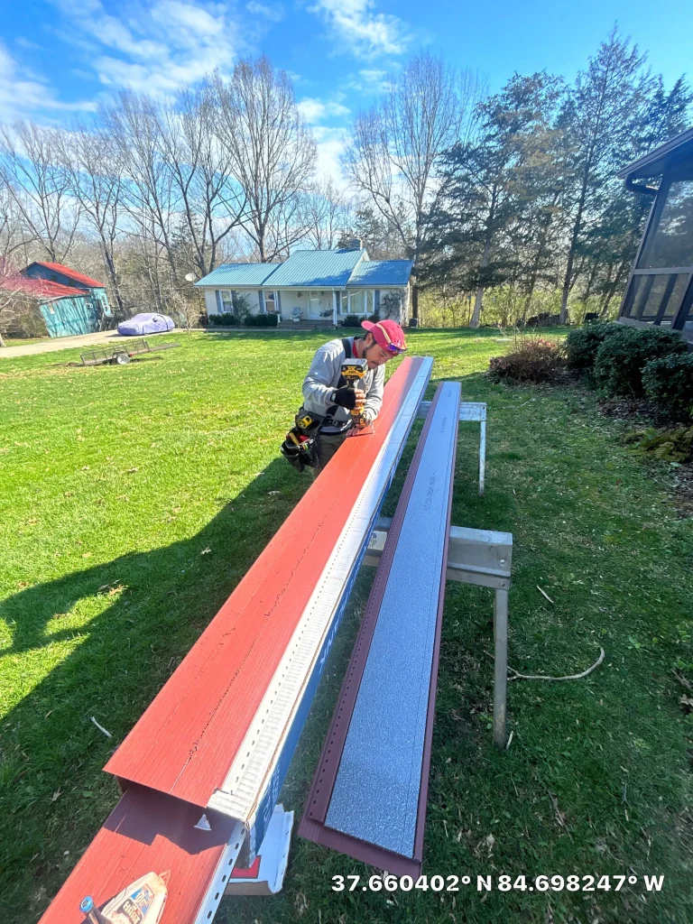 AIC worker trimming red siding pieces in preparation for installation in Lexington, KY.