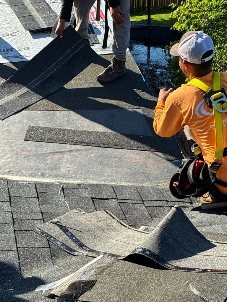 Roofers installing shingles during a roof repair on a Lexington, KY home by AIC Roofing