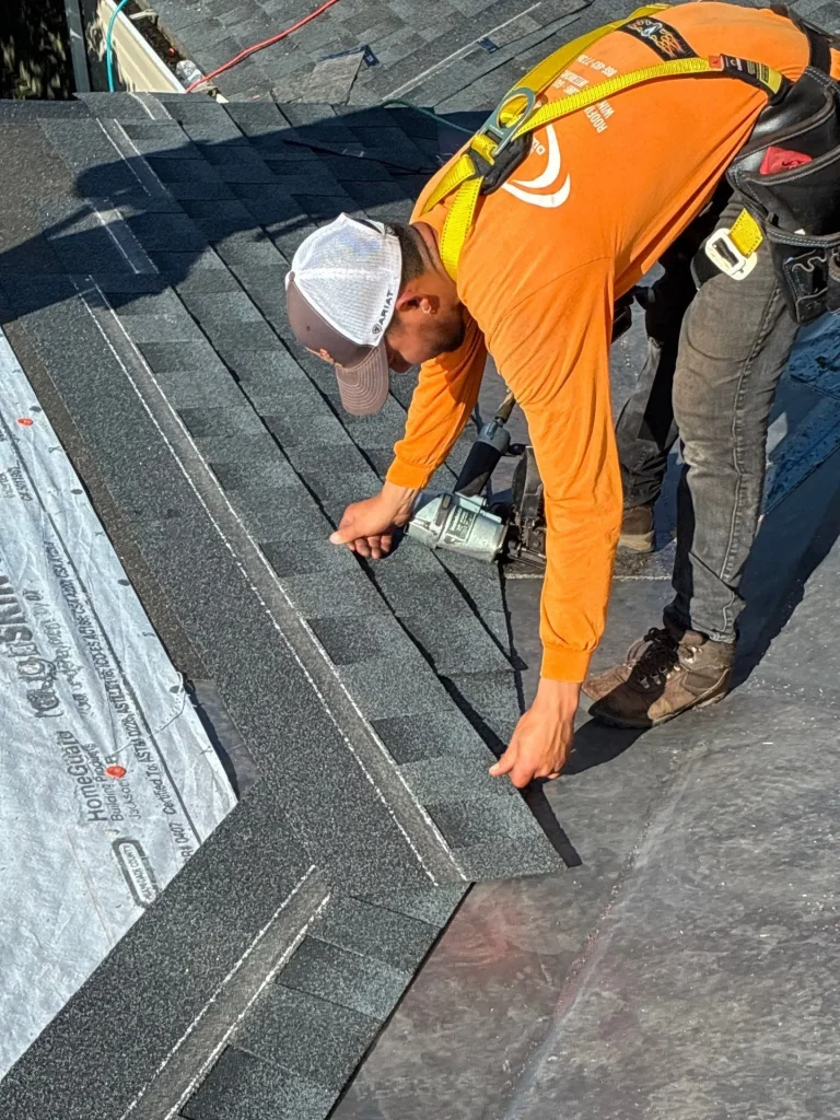 Roofer repairing shingles on a home in Lexington, KY, during a roof repair by AIC Roofing