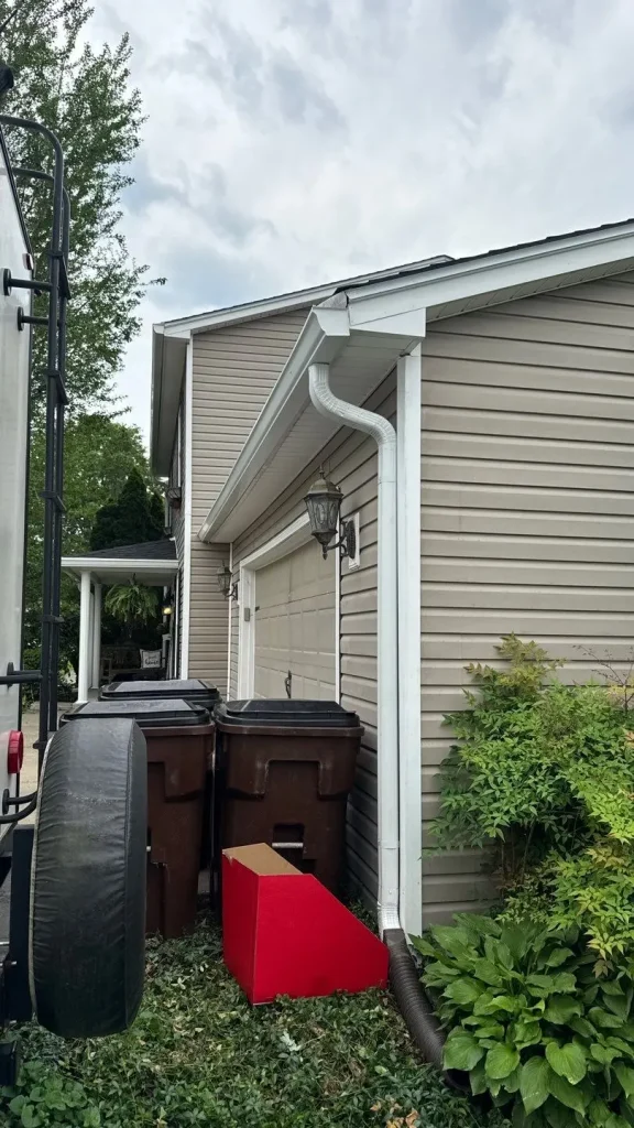 New gutter installation on the side of a garage in Lexington, KY, completed by AIC Roofing