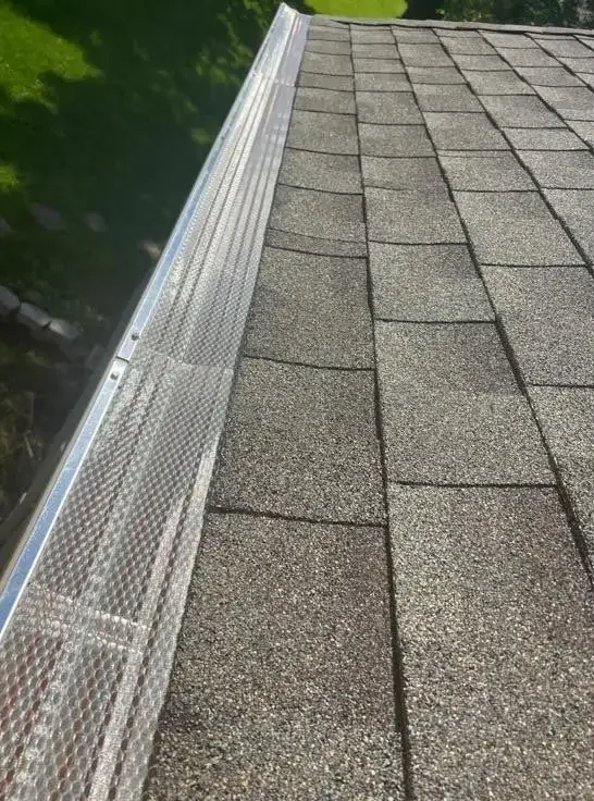 Close-up of newly installed gutter guards on a Richmond home by AIC Roofing & Construction.