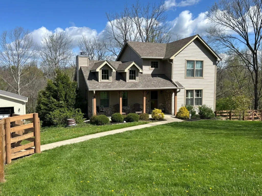 A two-story Richmond home with a new roof replacement installed by AIC Roofing & Construction.