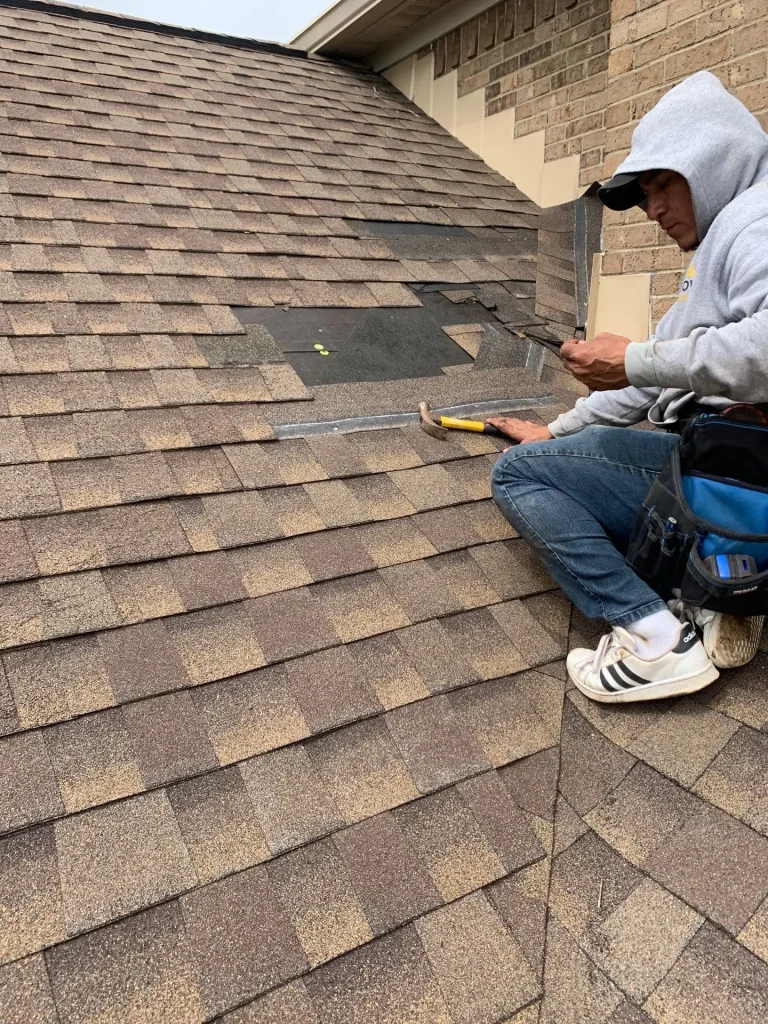 AIC Roofing & Construction worker repairing a roof on a Richmond home.
