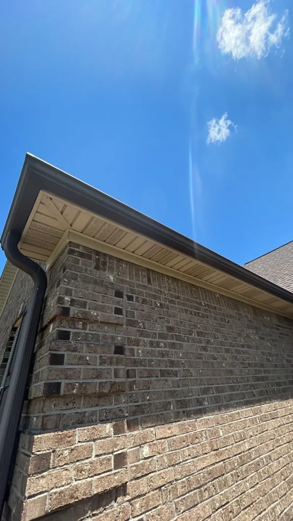 Close-up of a brown gutter system installed on a Richmond home by AIC Roofing & Construction.