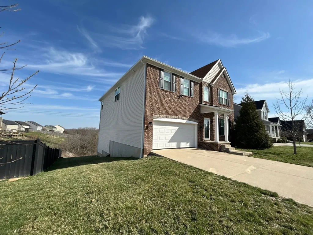 Brick home in Richmond with a new roof replacement completed by AIC Roofing & Construction.