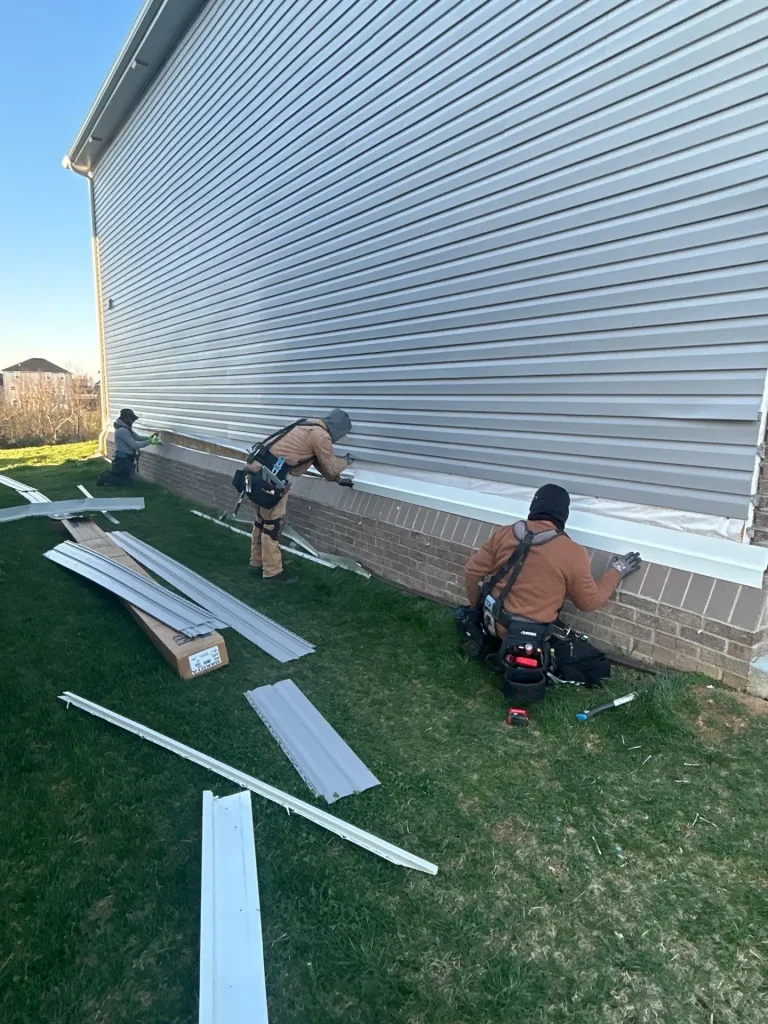 AIC Roofing & Construction crew working on a new siding installation for a Richmond home.