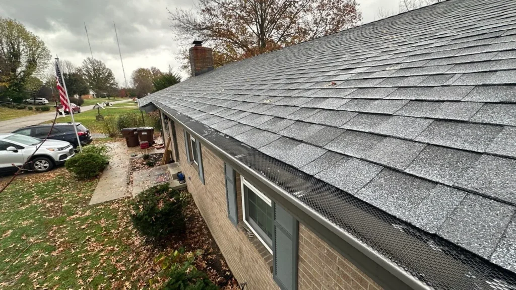 Newly installed gutter guard system on a Richmond home by AIC Roofing & Construction, shown from above with shingles and mesh visible.