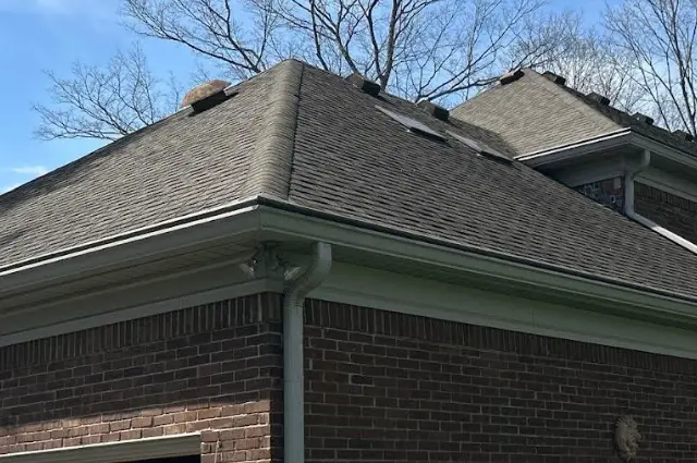 Gutter Installation in KY by AIC Roofing & Construction Close-up of new gutter installation on a brick home in KY by AIC Roofing & Construction.
