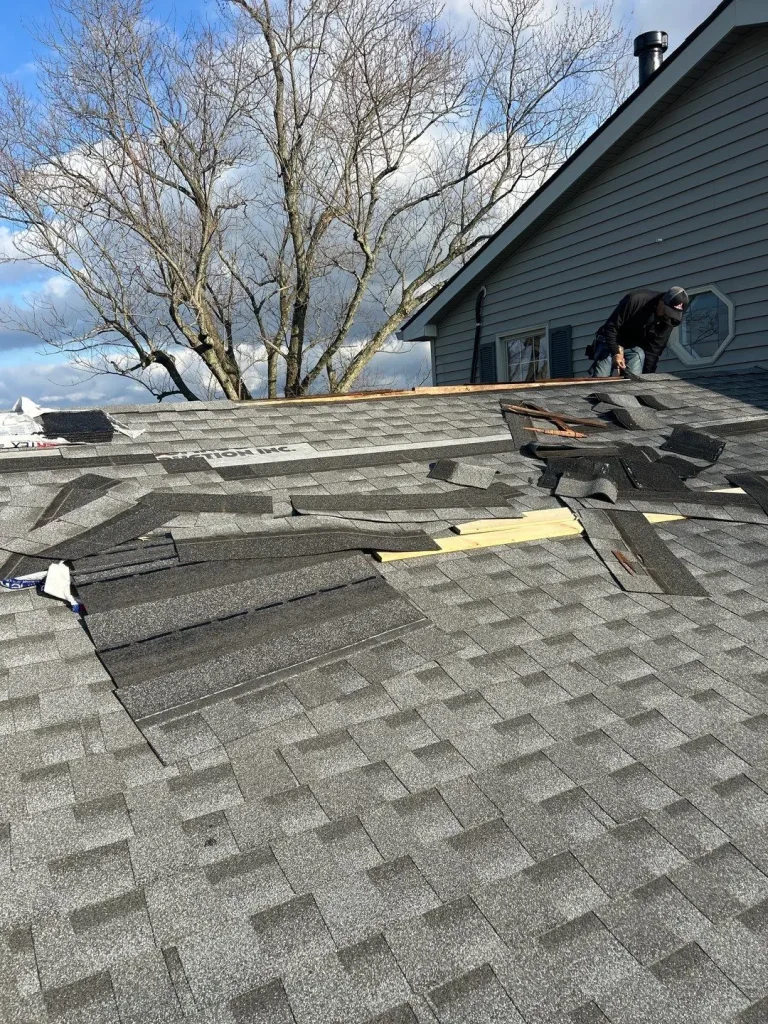 AIC Roofing & Construction crew member performing roof repairs on a Richmond home.