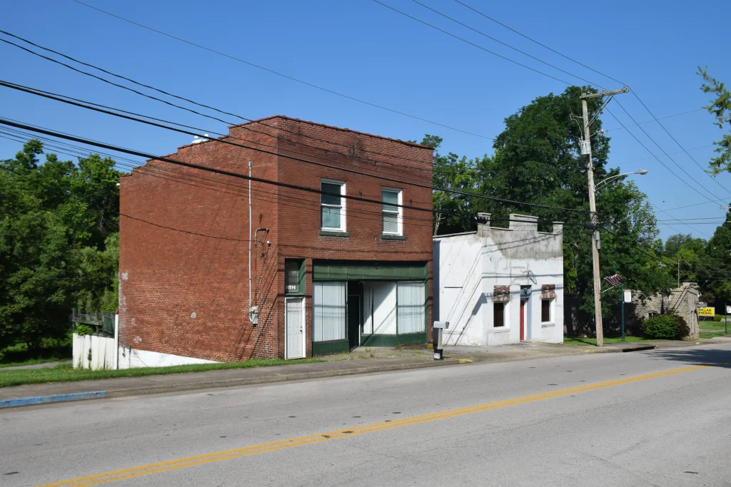 Historic brick and stucco buildings on a quiet street in downtown Stamping Ground, KY.