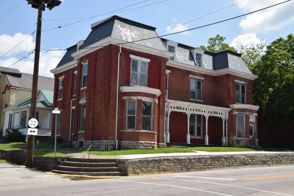 Historic red brick building with ornate white trim and slate roof in downtown Carlisle, KY, located near Route 32.