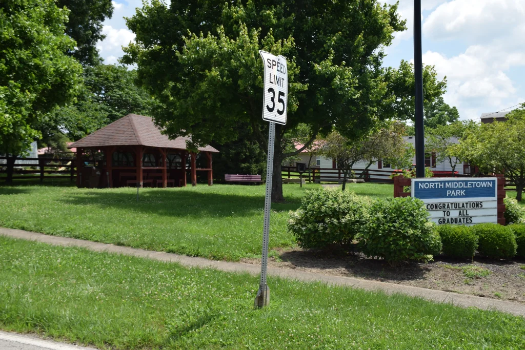 North Middletown Park in Kentucky with a wooden gazebo, green lawn, and a congratulatory sign for graduates.