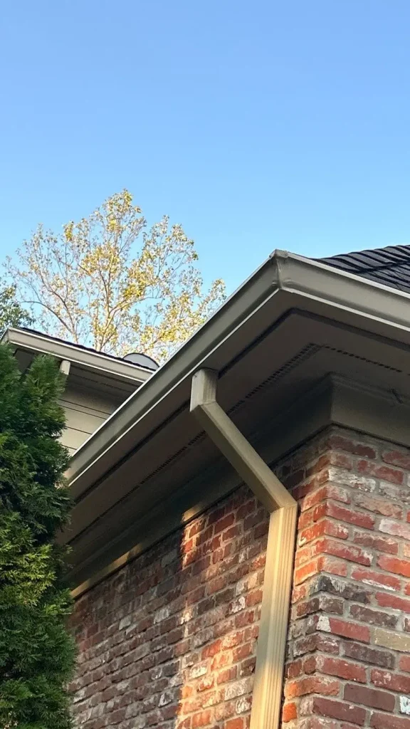 New seamless gutter system installed on a brick home in Fisherville, KY by AIC Roofing.