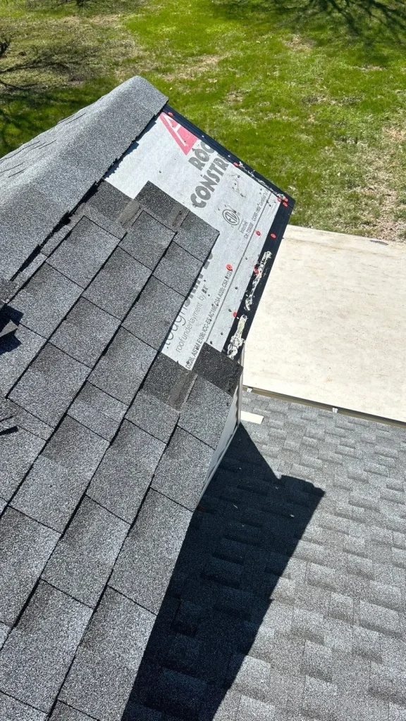 In-progress roof repair in Lexington, KY by AIC Roofing & Construction showing new shingle installation.