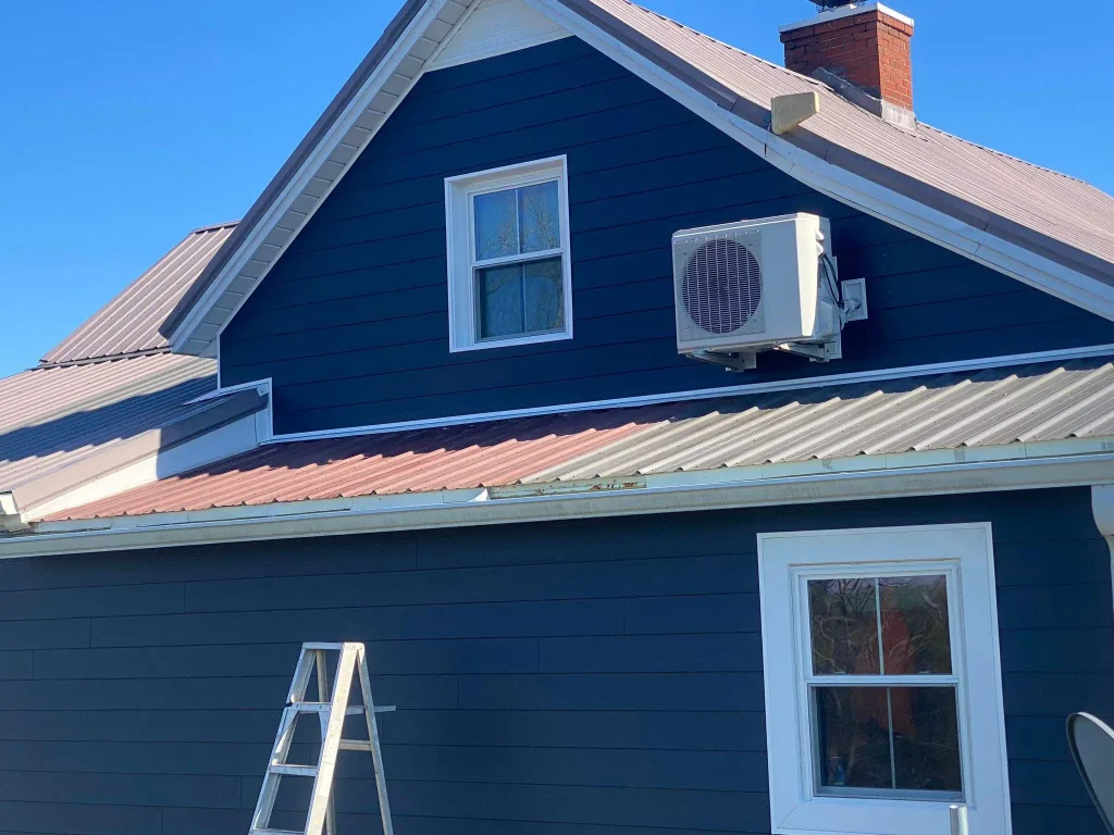 New navy blue siding installed on a home in Salvisa, KY by AIC Roofing & Construction.