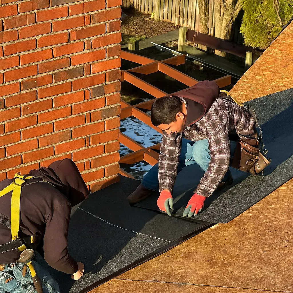 AIC Roofing crew members performing a roof repair around a chimney on a Lexington, KY home.