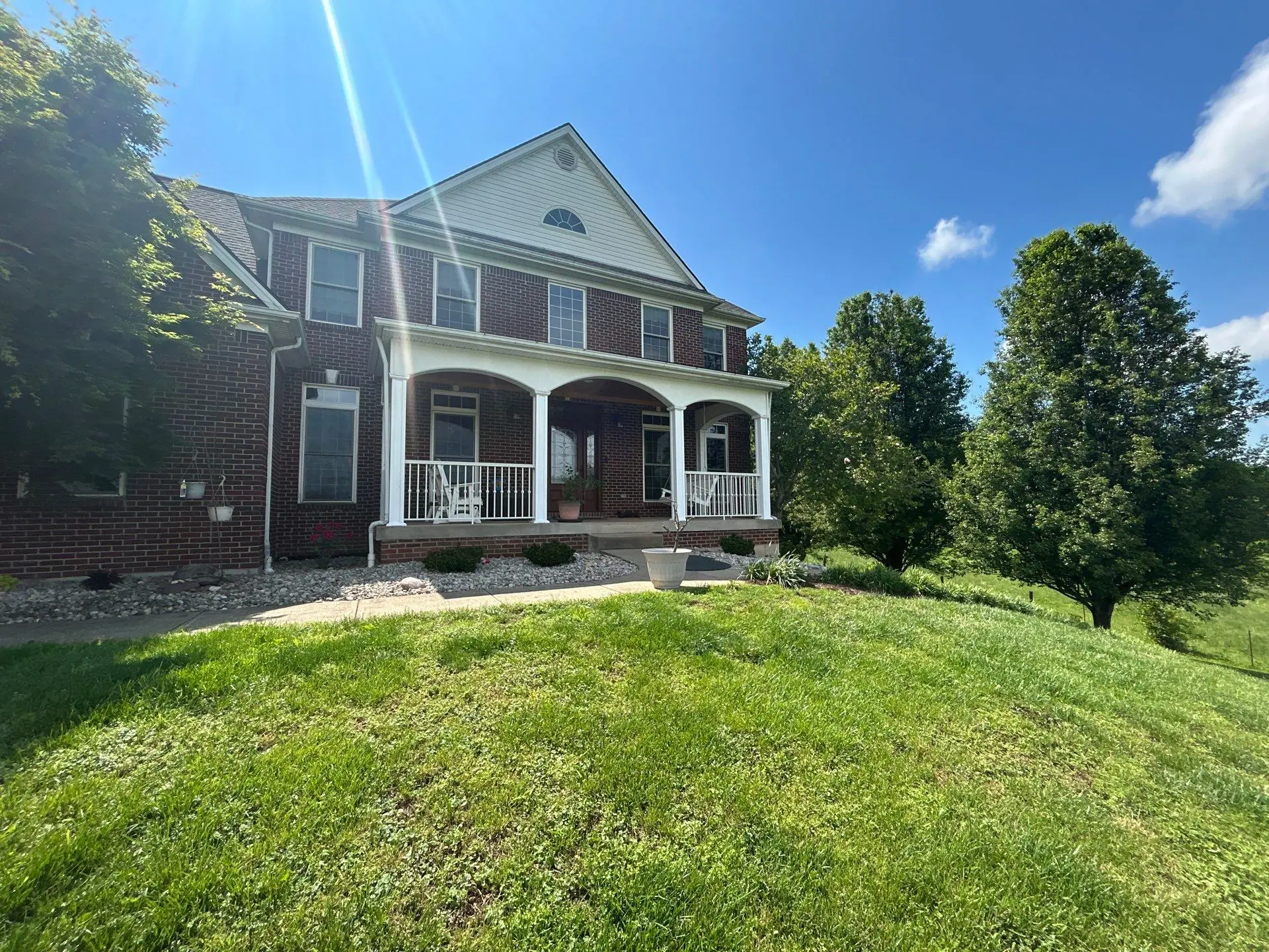 Roof replacement on a two-story brick home in Stamping Ground, KY completed by AIC Roofing & Construction.