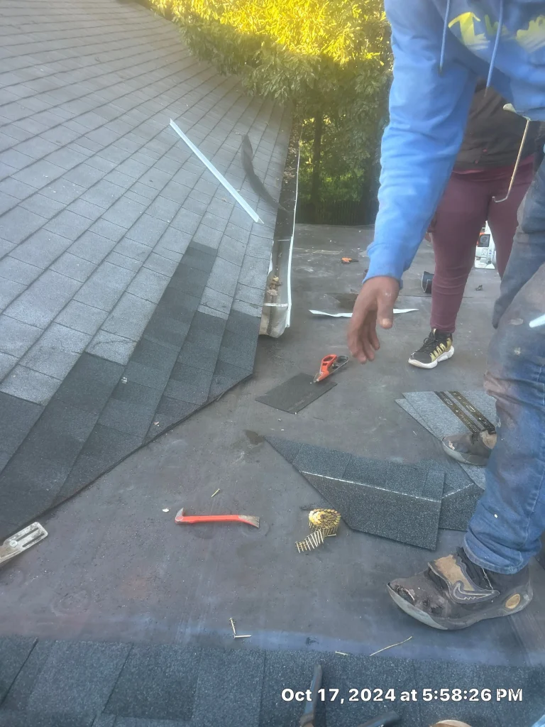 Roof repair in progress on a historic brick home in Perryville, KY, with AIC Roofing crew addressing areas near the roofline.