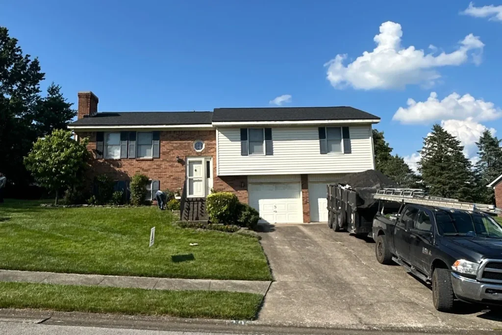 A Richmond, KY split-level home with a newly installed roof by AIC Roofing & Construction under a clear blue sky.