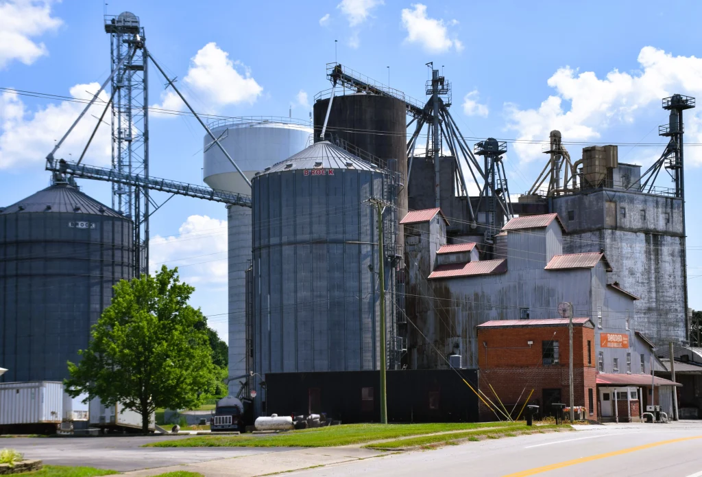 Industrial grain silos and metal-roofed feed mill in Bagdad, Kentucky.