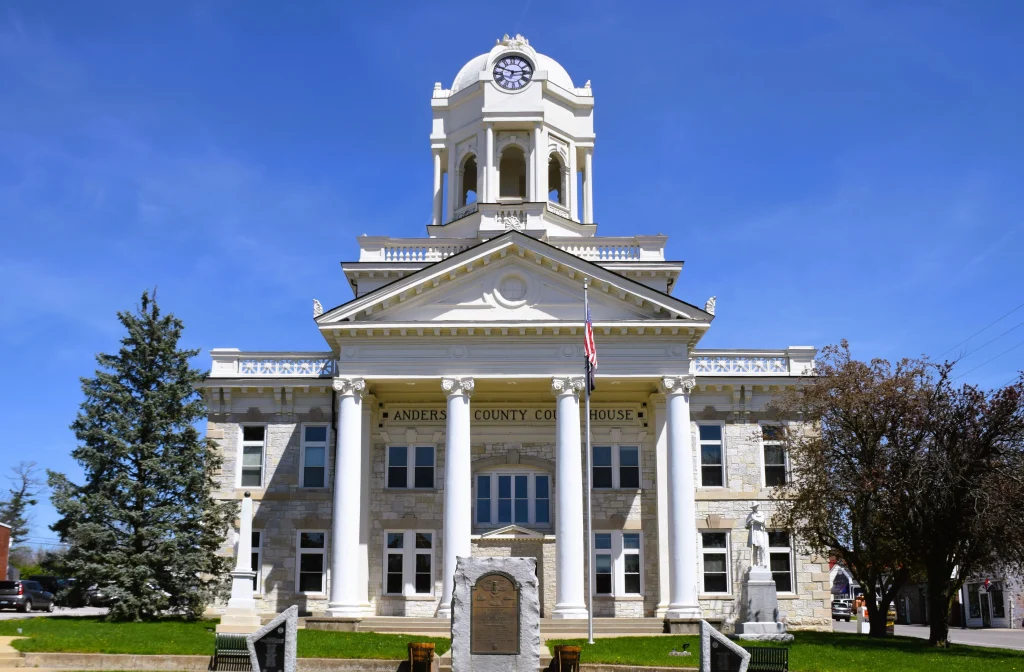 Front view of the Anderson County Courthouse in Lawrenceburg, KY under a clear blue sky