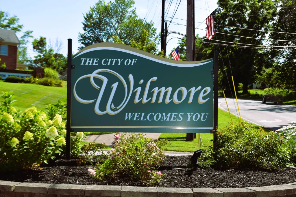 City of Wilmore entrance sign, surrounded by landscaping and homes needing Wilmore roofing services