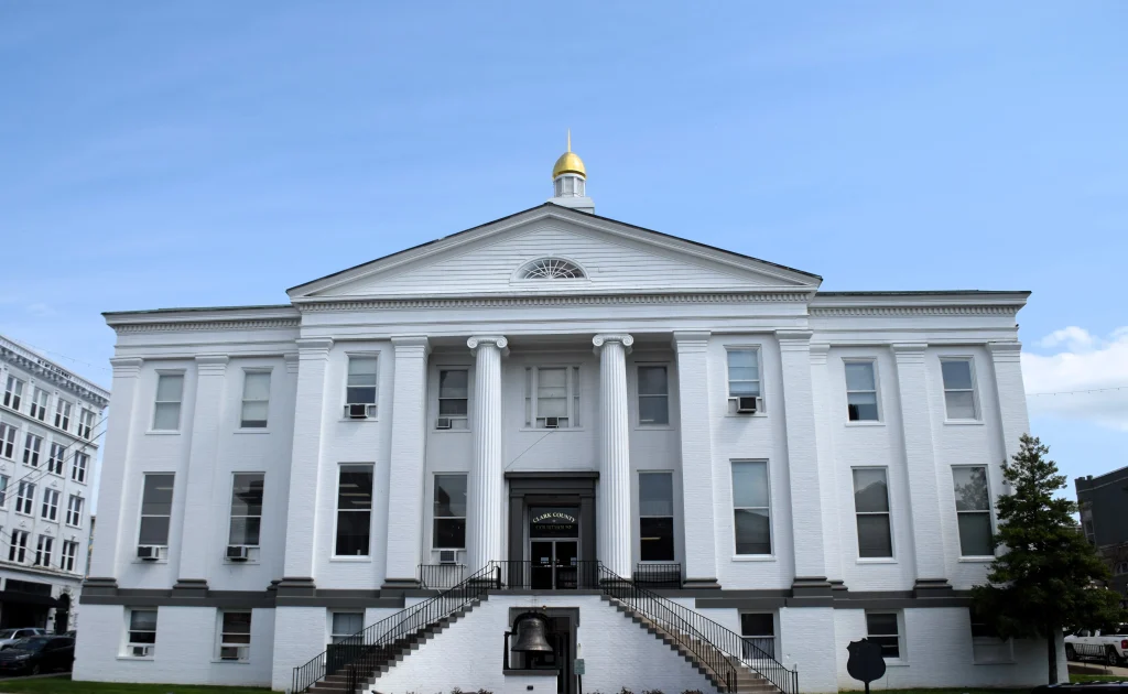 White historic courthouse in Winchester KY with columns and gold dome
