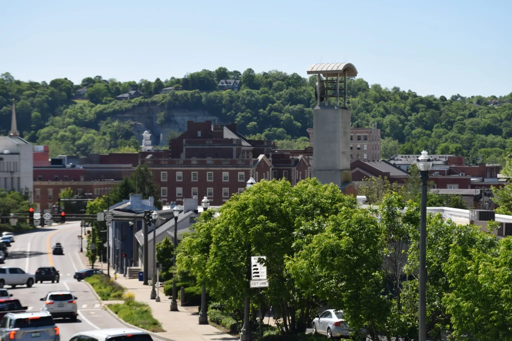 Downtown Frankfort KY with historic buildings, rooftops, and the Singing Bridge in the background