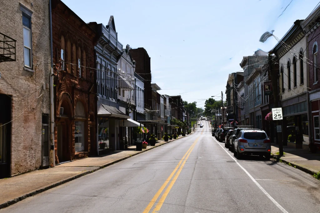 View down Main Street in Cynthiana Kentucky lined with shops and parked cars