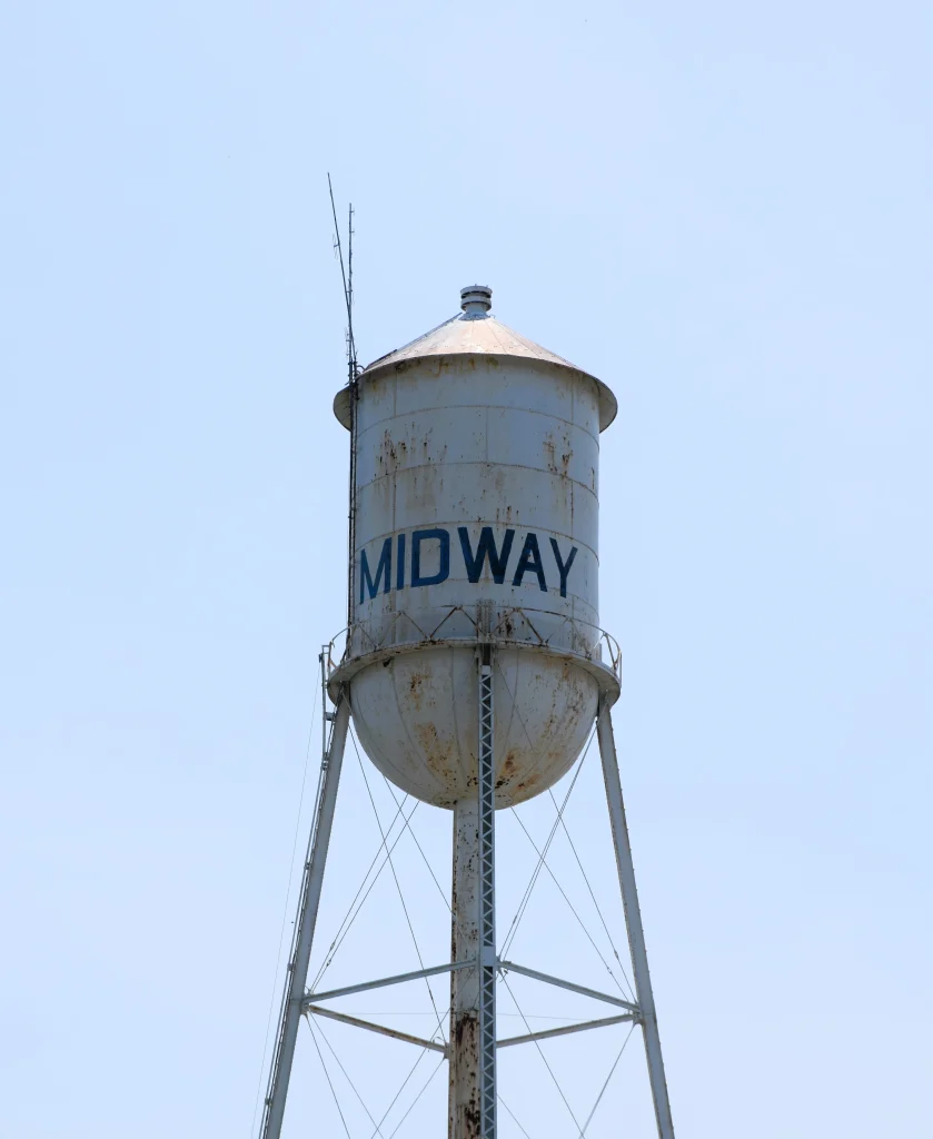 White water tower with “Midway” painted in blue letters