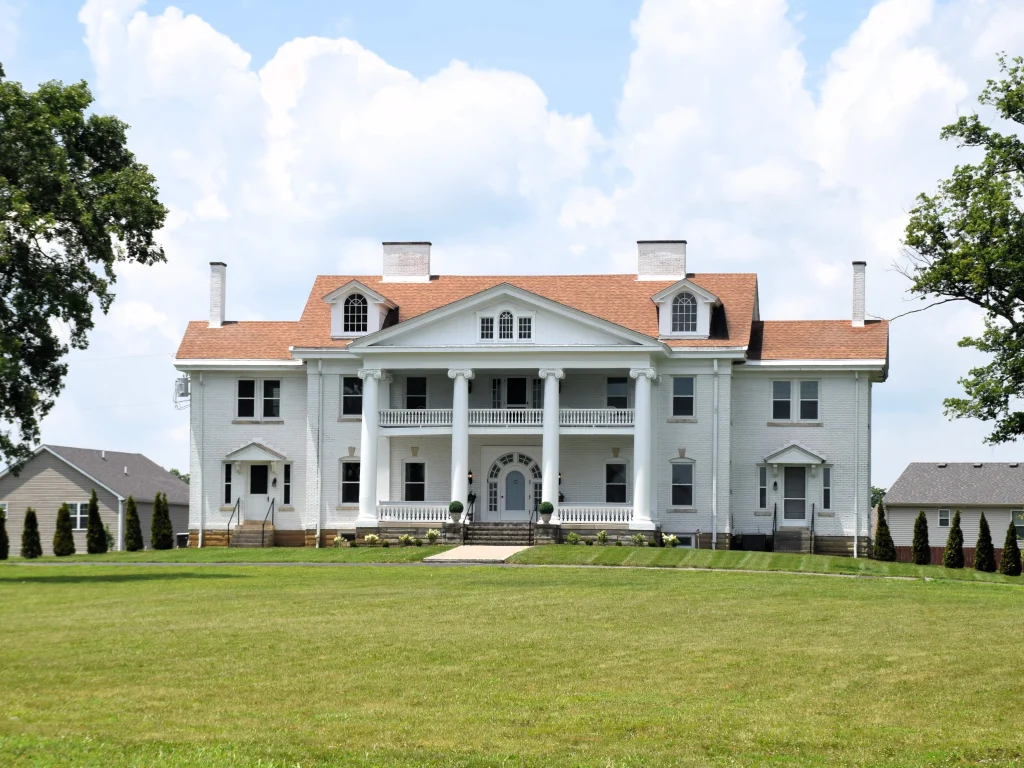 Large white estate-style home with a red roof in Nicholasville, KY