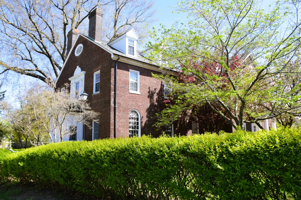 Historic red brick home with white trim and large trees in Danville KY.