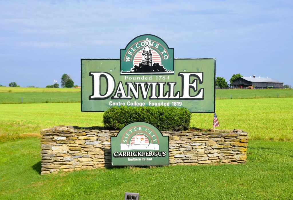 Welcome to Danville KY sign with green fields and a barn in the background.
