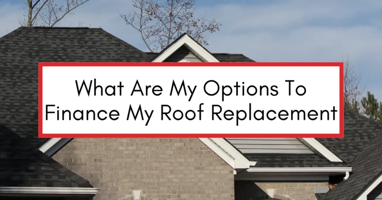 Front view of a brick home with a recently replaced dark gray shingle roof under a clear sky, illustrating a blog about financing options for roof replacement.