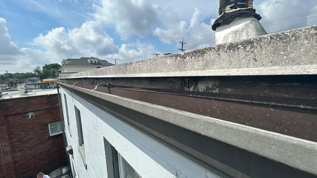 Old and weathered gutter system on a commercial building in Louisville