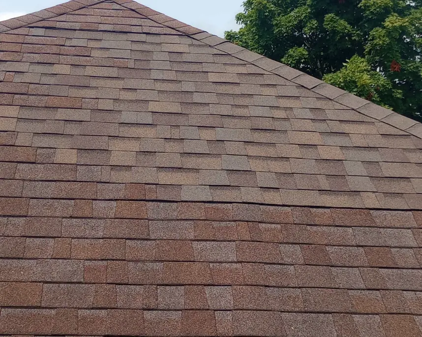 Aging Roof with Discolored Shingles on Louisville Building Faded and discolored brown shingles on a sloped roof in Louisville