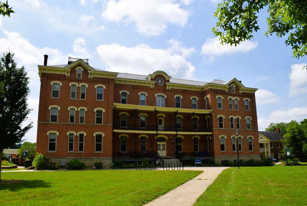 Historic brick college building with slate roofing and arched windows in Berea, Kentucky