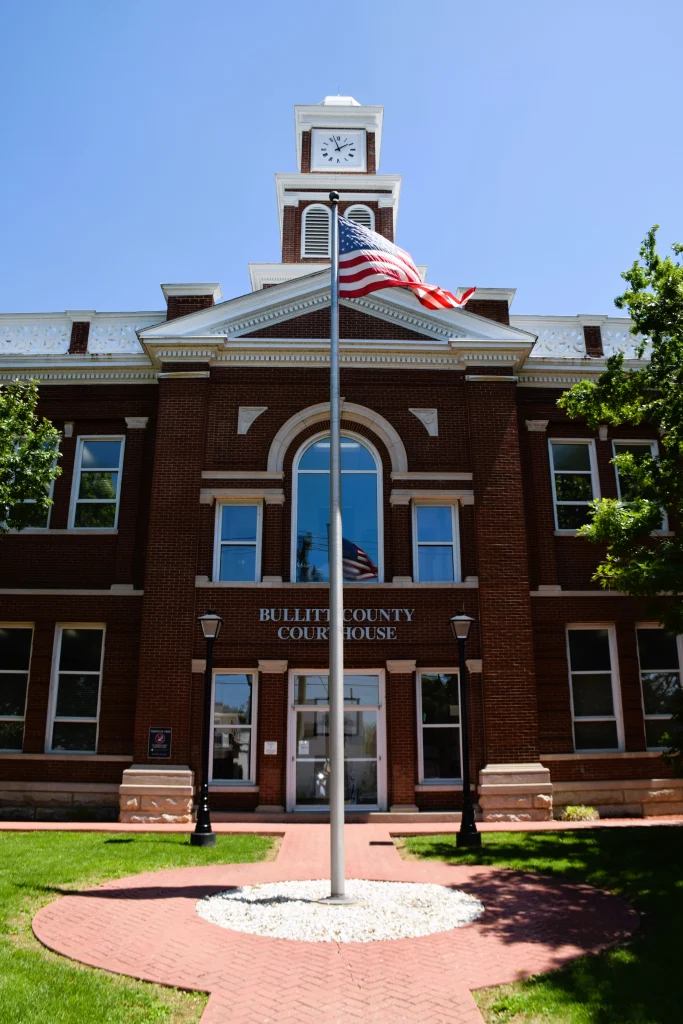 Bullitt County Courthouse in Shepherdsville with red brick and American flag