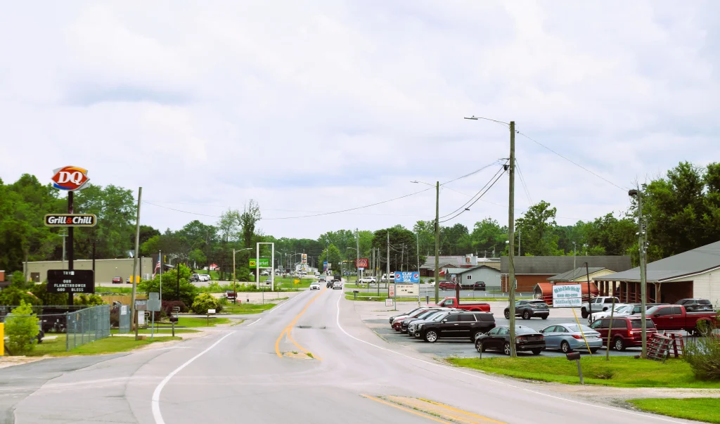 View of main road in Clay City, Kentucky with businesses and traffic, highlighting the service area for clay city roofing