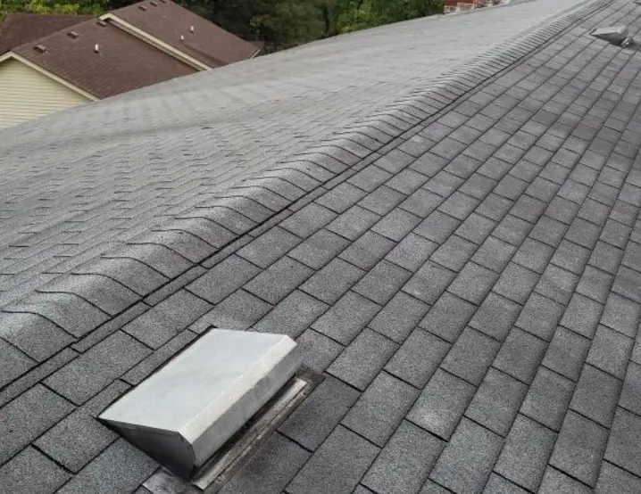 Discolored and aging gray shingles on a Louisville roof