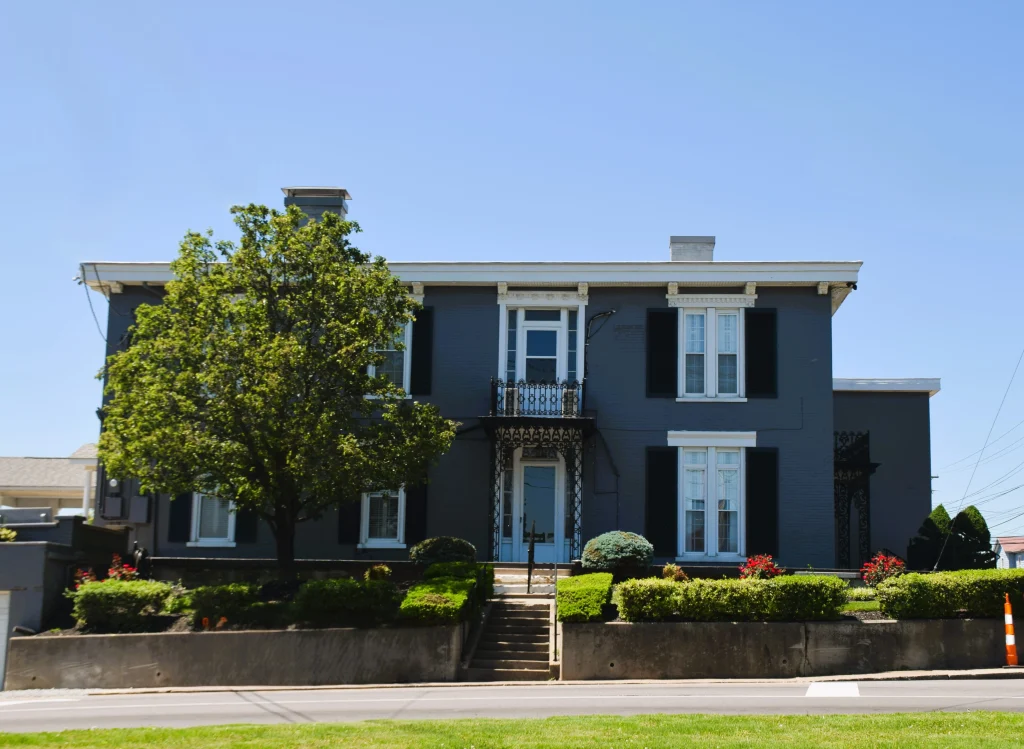 Blue historic house with white trim and balcony