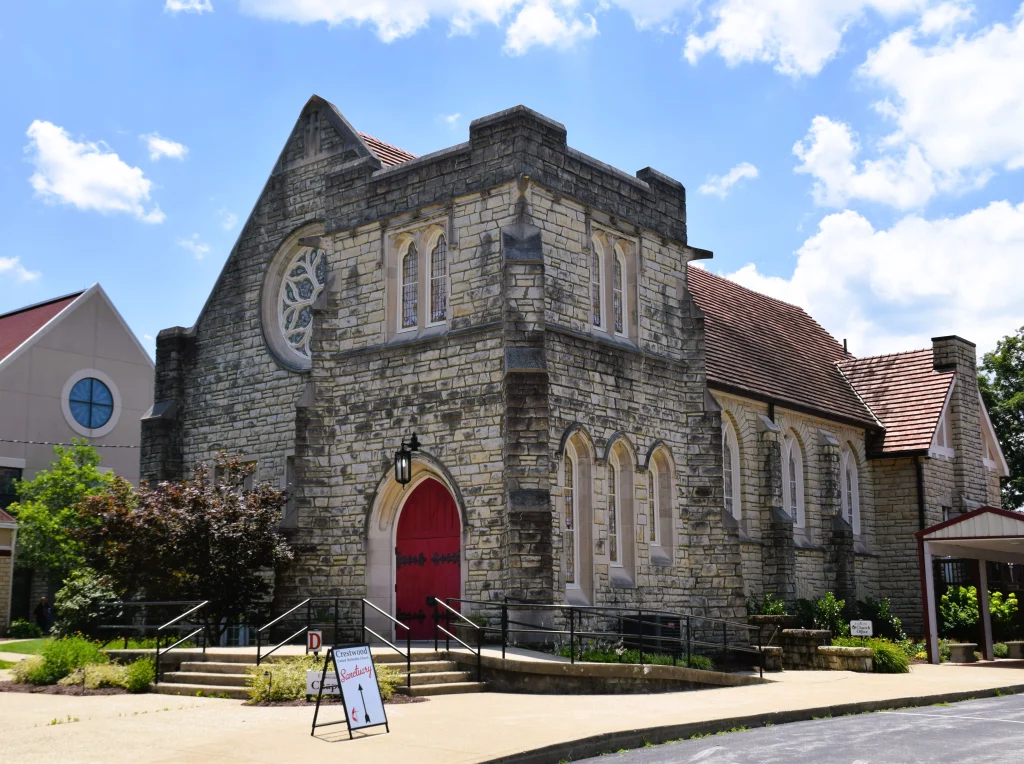 Stone church with red doors and slate roofing in Crestwood, Kentucky