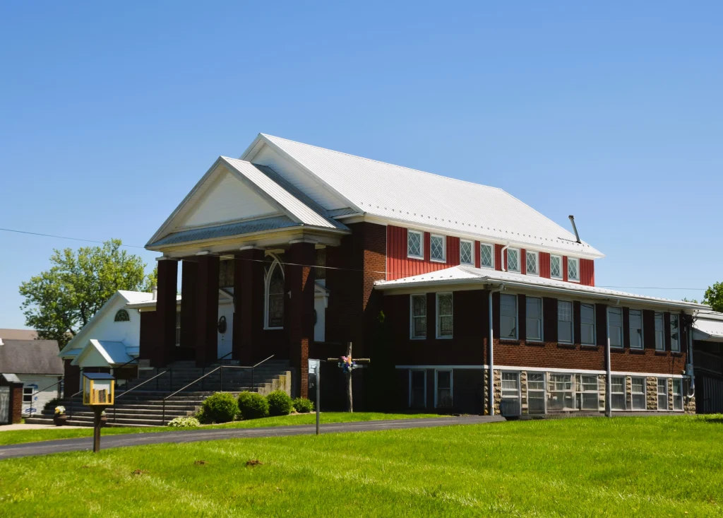 Red brick church in Mt. Eden, Kentucky with a white metal roof