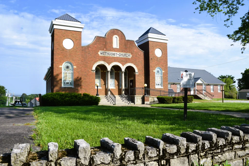 Brick Methodist church with towers and a metal roof in Bryantsville, Kentucky