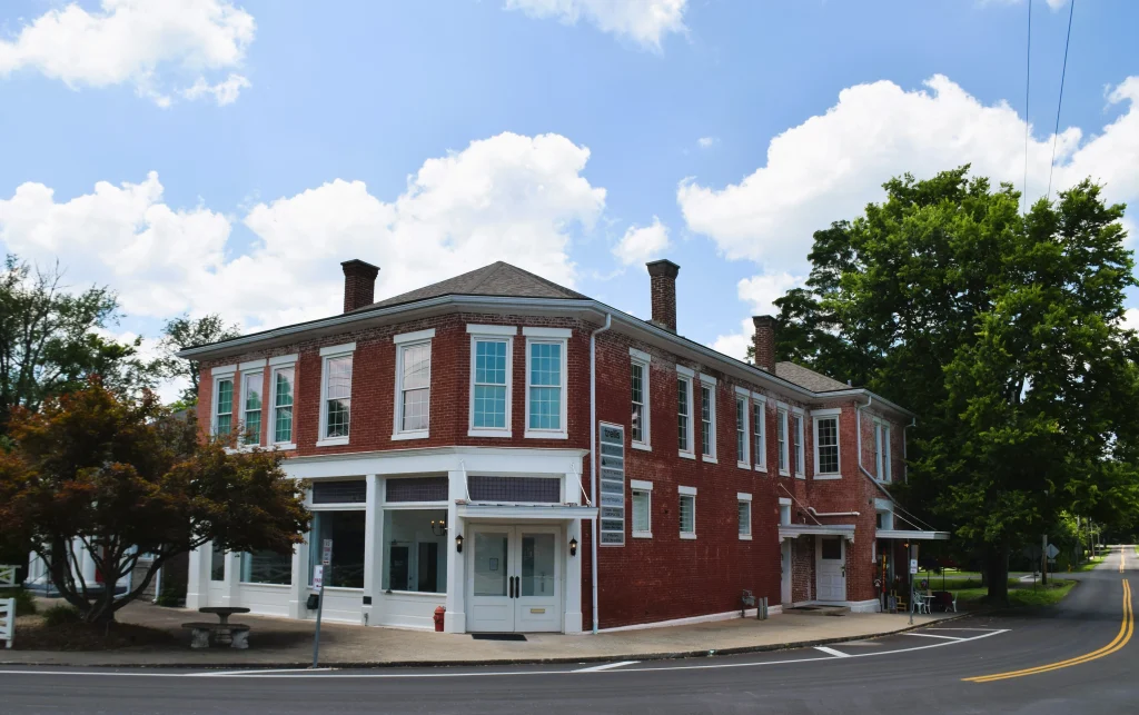 Restored red brick building in Pewee Valley Kentucky along a curved road