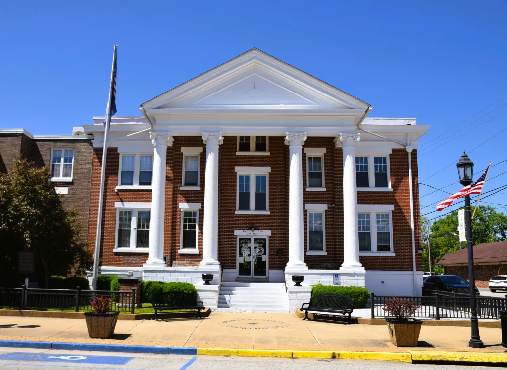 Taylorsville courthouse with classic brick and white columns, featuring a well-maintained roof by a local Taylorsville roofing contractor