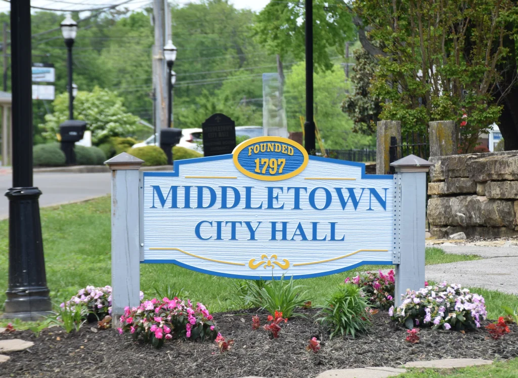 Sign for Middletown City Hall surrounded by flowers and greenery