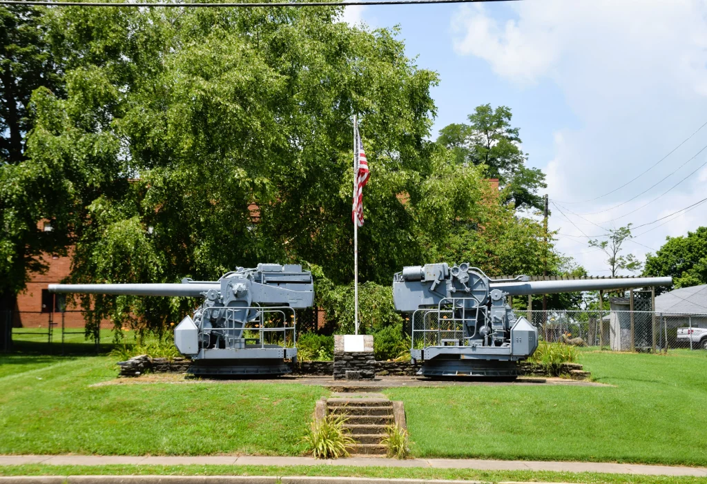 Twin naval guns and American flag at a veterans’ memorial in Lancaster