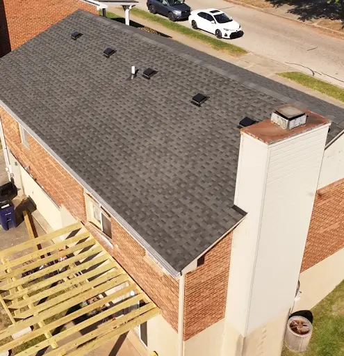 Dark asphalt shingle roof with multiple box vents on a two-story Lexington, KY home