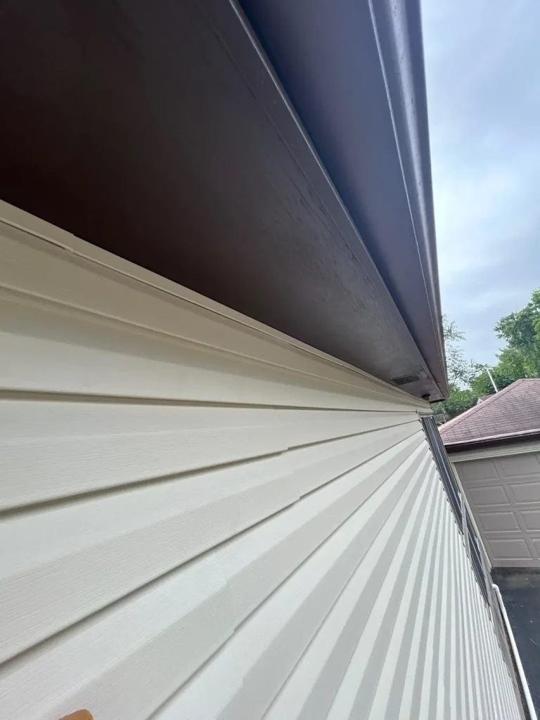 Close-up of newly installed vinyl siding and soffit on a Louisville home